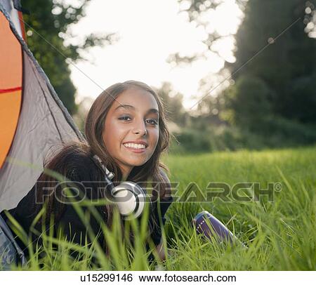 Teenage girl in headphones at campsite View Large Photo Image Stock Photograph - Teenage girl in headphones at campsite. Fotosearch