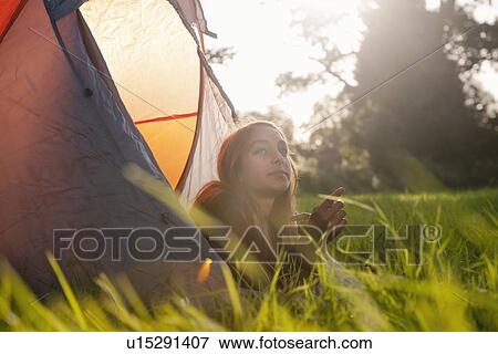 Teenage girl laying in tent at campsite View Large Photo Image Stock Photo - Teenage girl laying in tent at campsite. Fotosearch