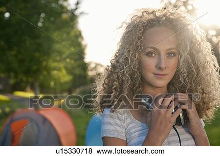 Teenage girl wearing headphones outdoors View Large Photo Image Stock Photo - Teenage girl wearing headphones outdoors. Fotosearch