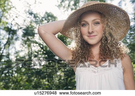 Teenage girl wearing straw hat outdoors View Large Photo Image Stock Photo - Teenage girl wearing straw hat outdoors. Fotosearch