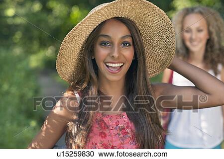 Teenage girl wearing straw hat View Large Photo Image Stock Image - Teenage girl wearing straw hat. Fotosearch