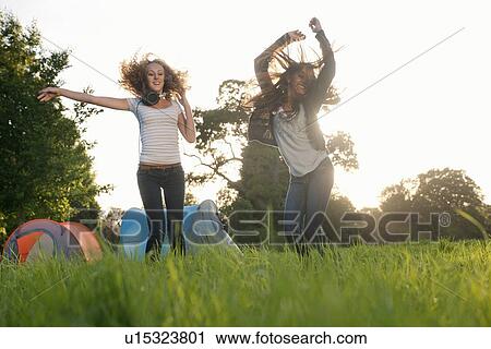 Teenage girls dancing in field View Large Photo Image Stock Image - Teenage girls dancing in field. Fotosearch