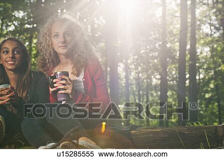 Stock Photography - Teenage girls having picnic in forest. Fotosearch