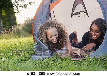 Teenage girls laying in tent at campsite View Large Photo Image Stock Photo - Teenage girls laying in tent at campsite. Fotosearch