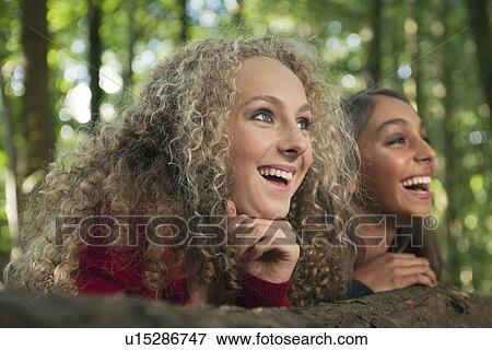 Teenage girls smiling in forest View Large Photo Image Stock Photo - Teenage girls smiling in forest. Fotosearch