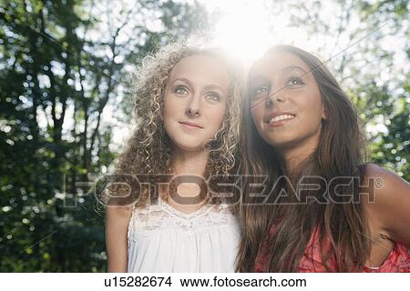 Teenage girls smiling outdoors View Large Photo Image Picture - Teenage girls smiling outdoors. Fotosearch
