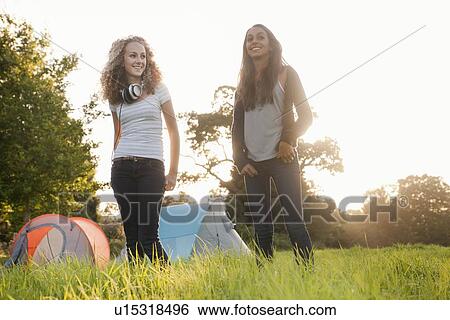 Stock Photograph - Teenage girls standing in field. Fotosearch