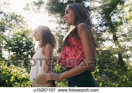 Teenage girls walking in forest View Large Photo Image Stock Photo - Teenage girls walking in forest. Fotosearch