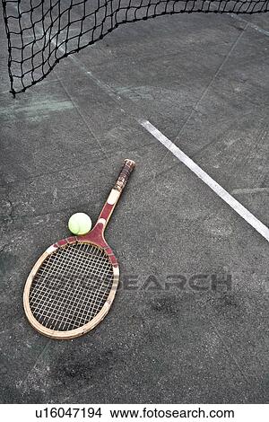 Picture - Tennis racket and ball on court. Fotosearch