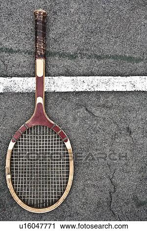 Stock Image - Tennis racket on court. Fotosearch