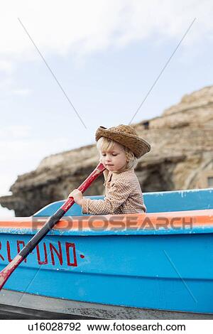 Toddler girl rowing boat on beach View Large Photo Image Stock Image - Toddler girl rowing boat on beach. Fotosearch