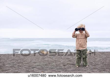 Toddler girl using binoculars on beach View Large Photo Image Stock Image - Toddler girl using binoculars on beach. Fotosearch