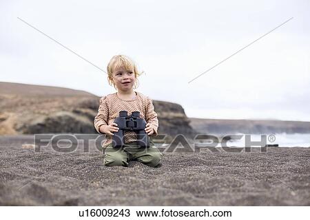 Toddler girl using binoculars on beach View Large Photo Image Stock Image - Toddler girl using binoculars on beach. Fotosearch
