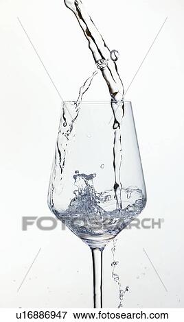 Stock Photo - Water pouring in wine glass. Fotosearch