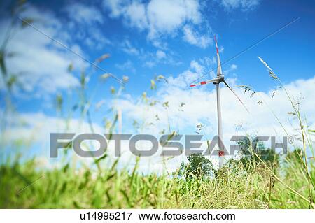 Stock Photo - Wind turbine in grassy rural field. Fotosearch