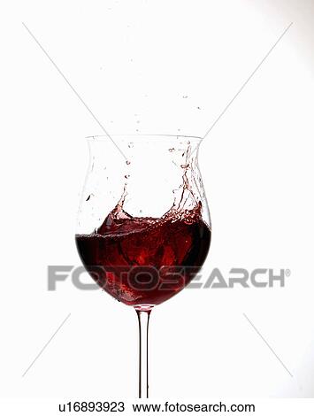 Stock Image - Wine splashing in glass. Fotosearch