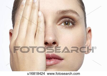 Woman covering her face with hand View Large Photo Image Picture - Woman covering her face with hand. Fotosearch