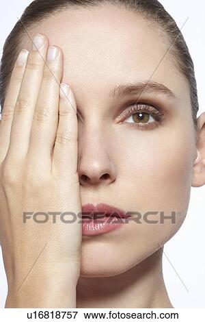 Stock Photo - Woman covering her face with hand. Fotosearch
