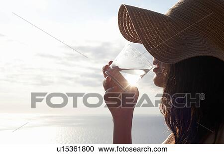 Woman drinking glass of water outdoors View Large Photo Image Stock Image - Woman drinking glass of water outdoors. Fotosearch
