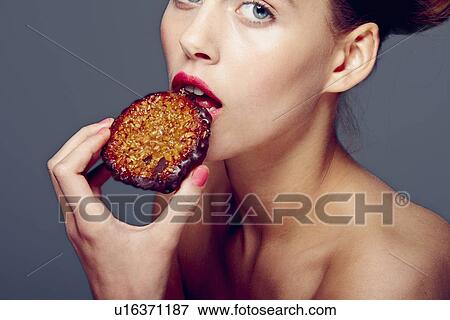 Woman eating cookie View Large Photo Image Stock Photo - Woman eating cookie. Fotosearch