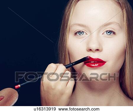 Woman having makeup applied View Large Photo Image Stock Photo - Woman having makeup applied. Fotosearch