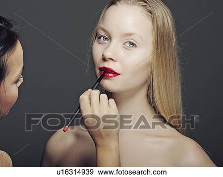 Woman having makeup applied View Large Photo Image Stock Photo - Woman having makeup applied. Fotosearch