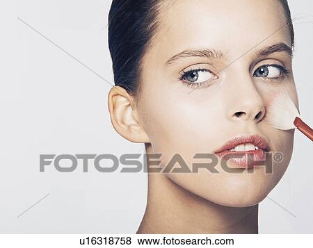 Woman having makeup applied View Large Photo Image Stock Photo - Woman having makeup applied. Fotosearch