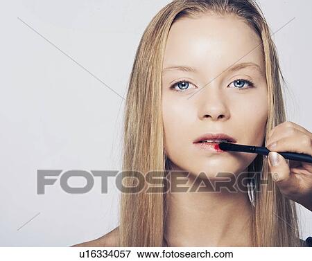 Woman having makeup applied View Large Photo Image Stock Photo - Woman having makeup applied. Fotosearch