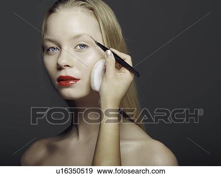 Stock Photo - Woman having makeup applied. Fotosearch