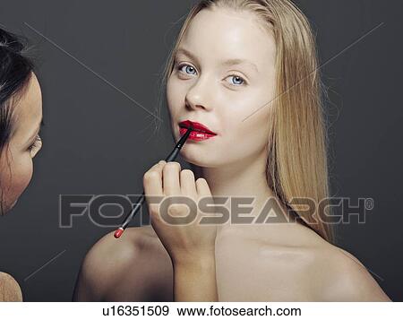 Woman having makeup applied View Large Photo Image Stock Photo - Woman having makeup applied. Fotosearch