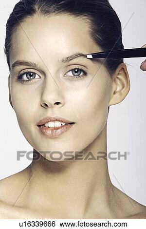 Woman having makeup applied View Large Photo Image Stock Photograph - Woman having makeup applied. Fotosearch