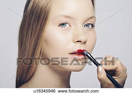 Woman having makeup applied View Large Photo Image Stock Photograph - Woman having makeup applied. Fotosearch