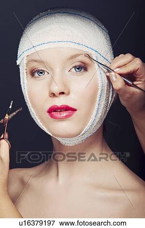 Woman in bandages having makeup applied View Large Photo Image Stock Photo - Woman in bandages having makeup applied. Fotosearch