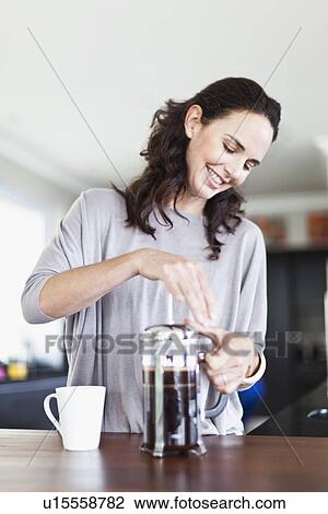 Woman making french press coffee View Large Photo Image Stock Image - Woman making french press coffee. Fotosearch