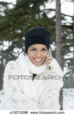 Woman on cell phone in snowy forest View Large Photo Image Stock Photograph - Woman on cell phone in snowy forest. Fotosearch