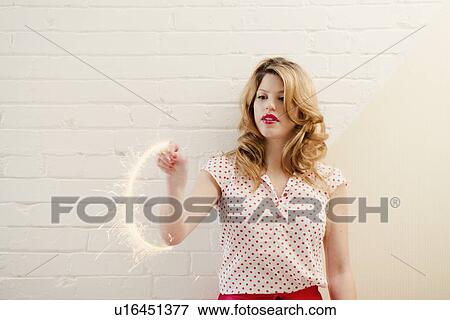 Stock Photo - Woman painting with sparklers. Fotosearch