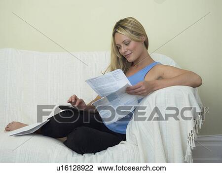 Woman paying bills on sofa View Large Photo Image Stock Image - Woman paying bills on sofa. Fotosearch