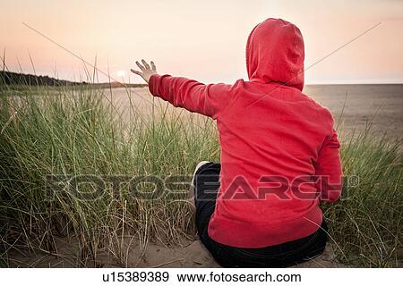 Stock Photo - Woman reaching toward beach. Fotosearch