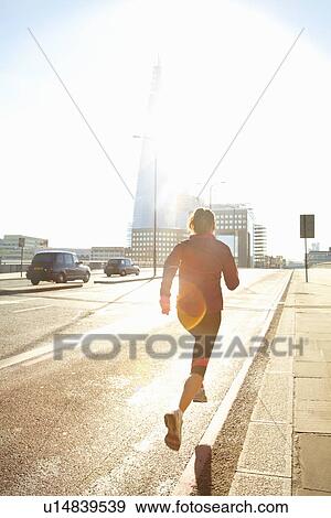 Stock Photo - Woman running on city street. Fotosearch