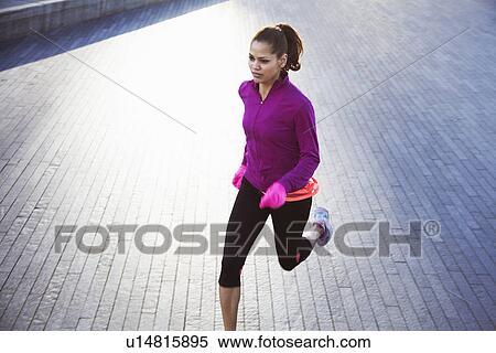 Stock Photography - Woman running on city street. Fotosearch