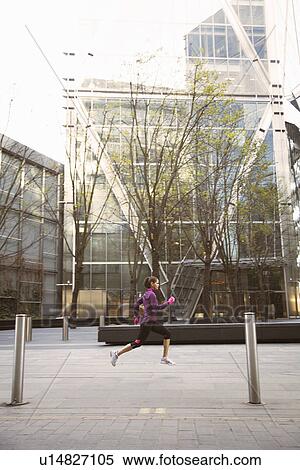 Stock Photography - Woman running on city street. Fotosearch