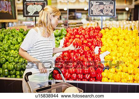 Woman shopping in grocery store View Large Photo Image Picture - Woman shopping in grocery store. Fotosearch