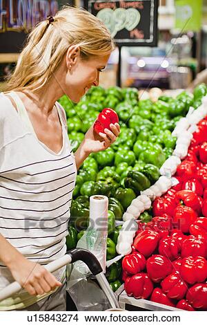Picture - Woman shopping in grocery store. Fotosearch