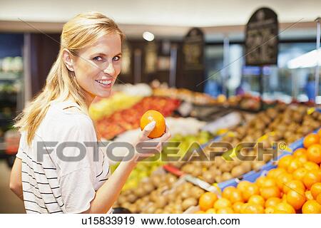 Woman shopping in grocery store View Large Photo Image Stock Photo - Woman shopping in grocery store. Fotosearch