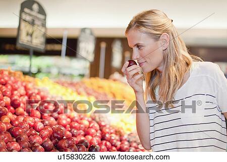 Woman shopping in grocery store View Large Photo Image Stock Photograph - Woman shopping in grocery store. Fotosearch
