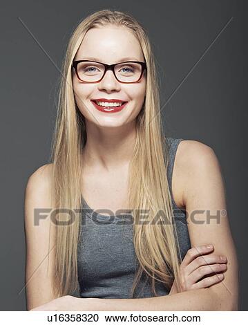 Stock Image - Woman smiling with arms crossed. Fotosearch
