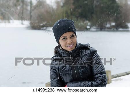 Stock Photo - Woman standing in snowy field. Fotosearch