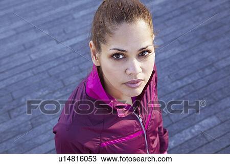 Woman standing on city street View Large Photo Image Stock Image - Woman standing on city street. Fotosearch