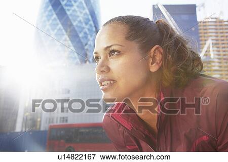 Woman standing on city street View Large Photo Image Stock Photo - Woman standing on city street. Fotosearch