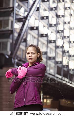 Stock Photo - Woman stretching on city street. Fotosearch